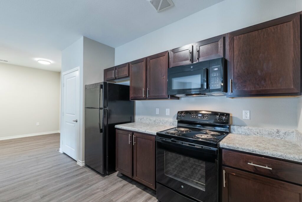 Kitchen in Menchaca Commons apartment with black appliances